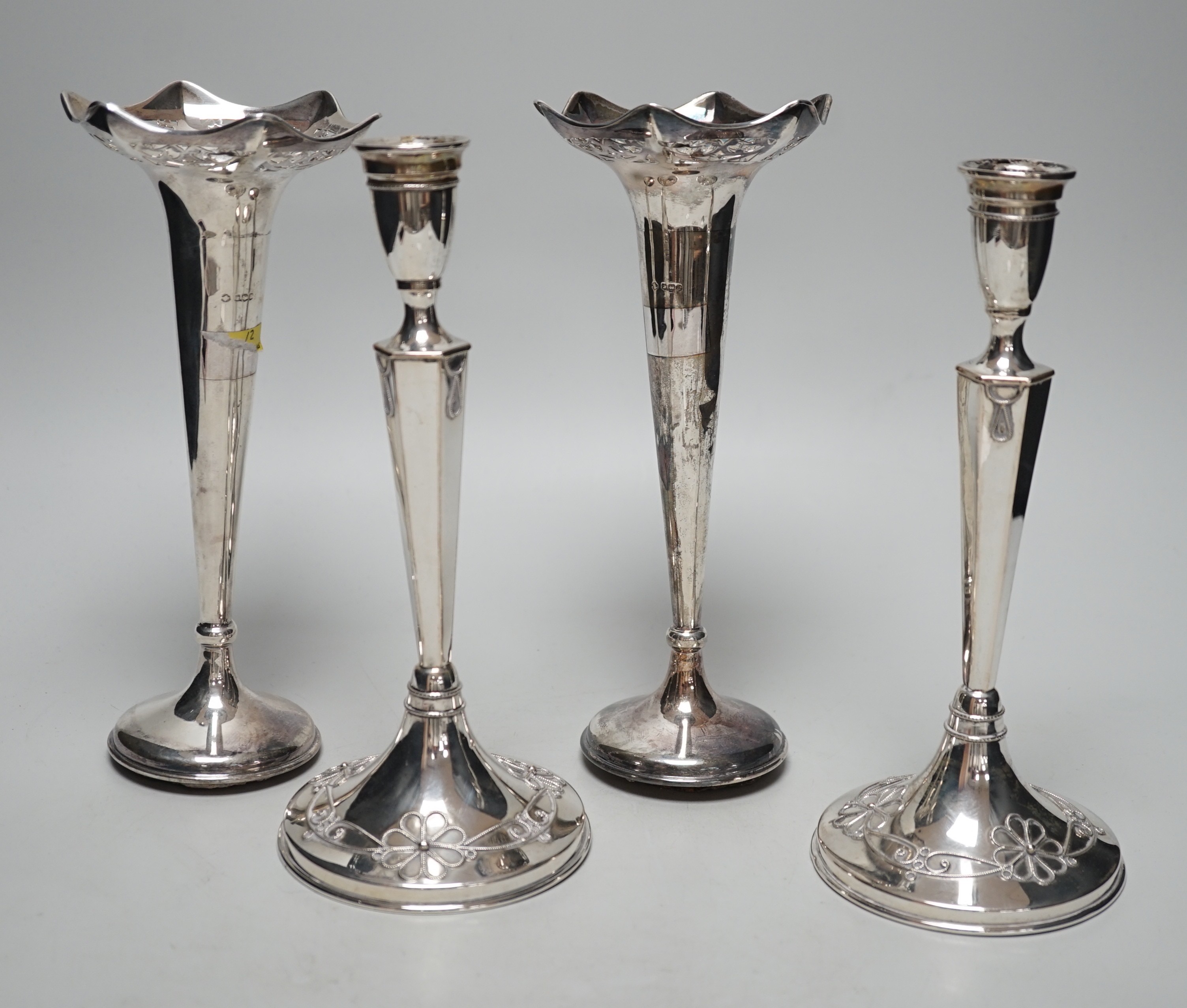 A pair of George V silver mounted posy vases, 22.3cm, weighted and a pair of German 800 standard white metal mounted candlesticks, weighted.